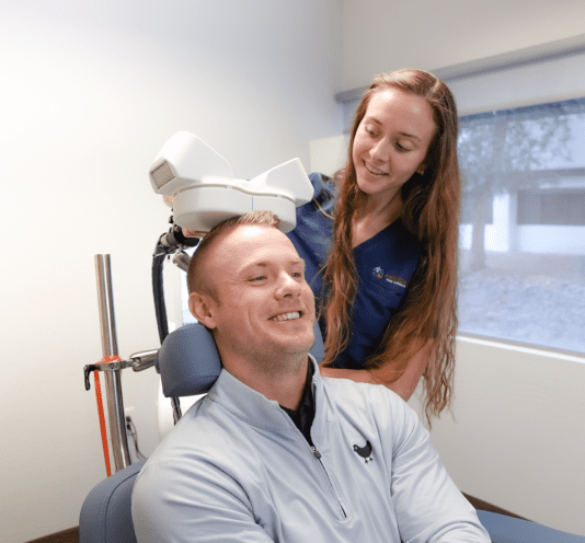 Young man receiving TMS therapy